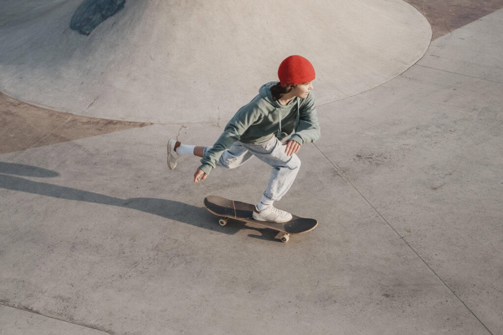 A teenager on a skateboard enjoying the skatepark