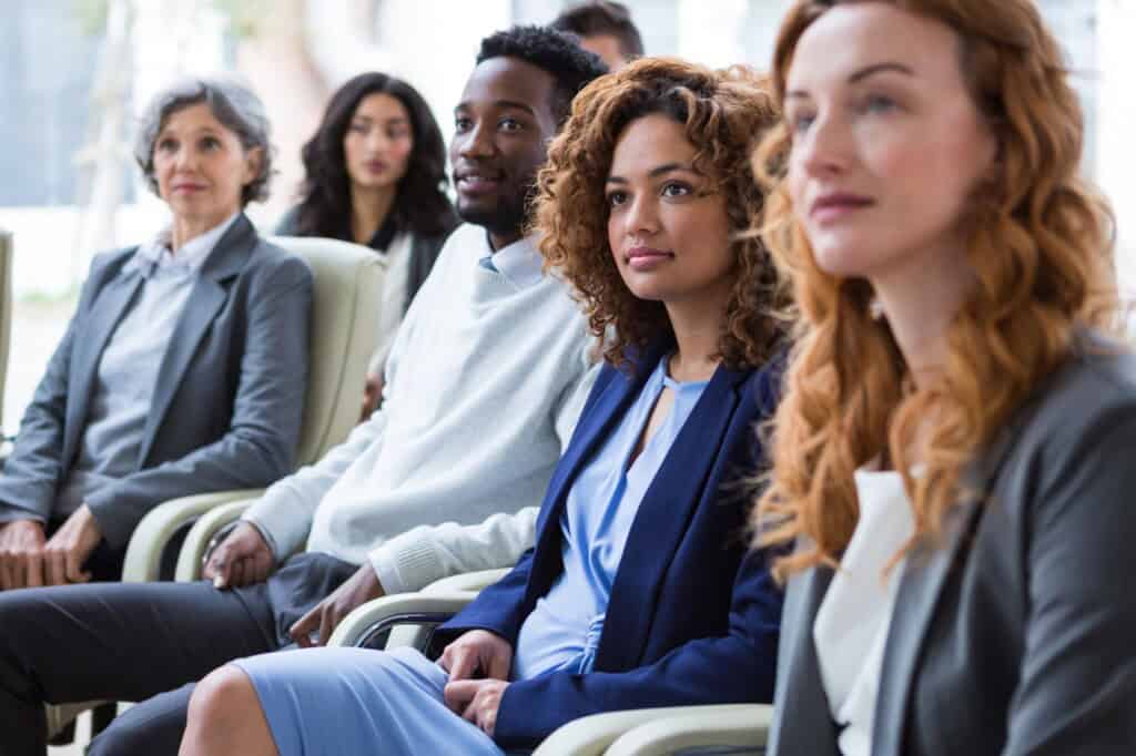 Employees seated for an announcement of the office relocation in the concept of 'How to Inform Employees About an Office Move to Bromley'.