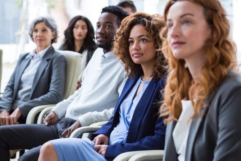 Employees seated for an announcement of the office relocation in the concept of 'How to Inform Employees About an Office Move to Bromley'.