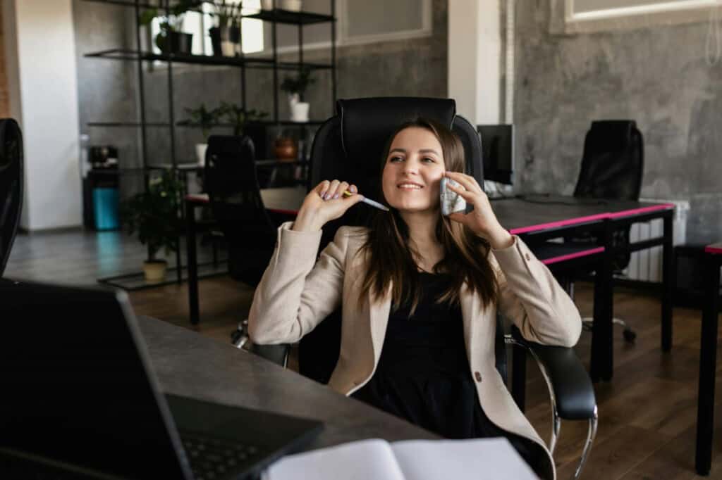 A female employee speaking with the company's partner on the phone about the office relocation